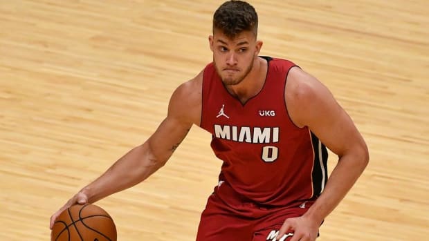 Heat center Meyers Leonard dribbles a basketball in a game.